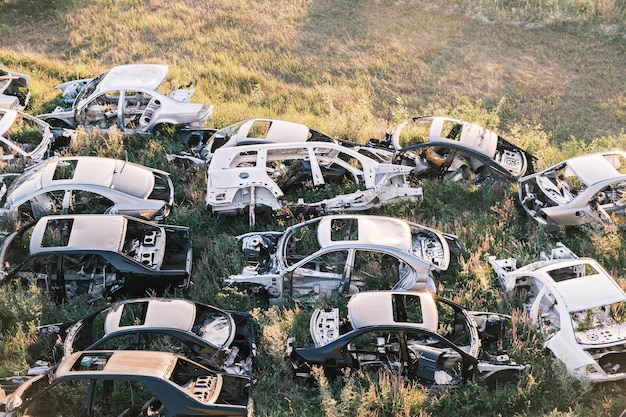 Foto volcado de coches rotos viejos coches oxidados tirado en la hierba