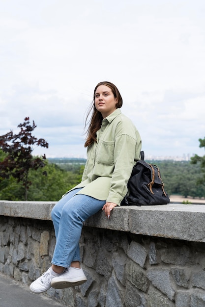 Foto voll erschossene frau, die draußen sitzt