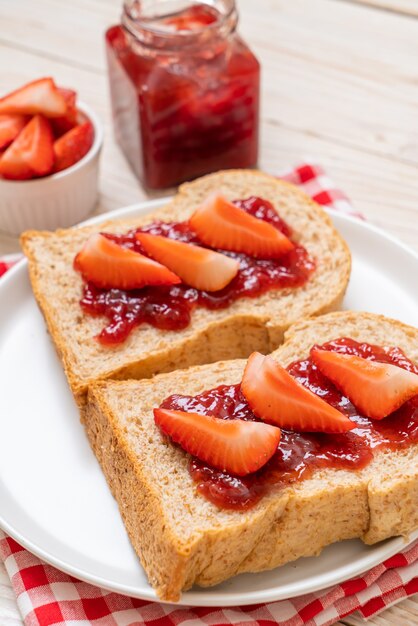 Vollkornbrot mit Erdbeermarmelade und frischer Erdbeere