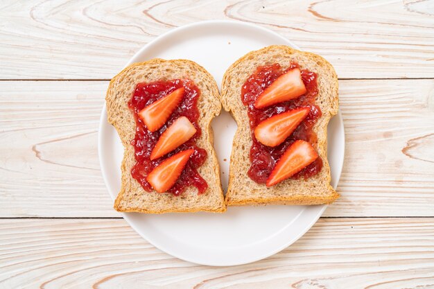 Vollkornbrot mit Erdbeermarmelade und frischer Erdbeere