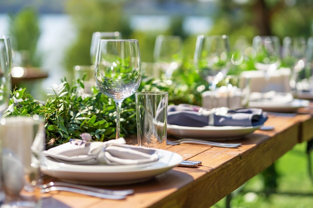 Vorbereitung auf eine Open-Air-Party. Mit frischen Blumen dekoriert serviert Tische. Tisch Nummer. Dekorationsdetails.