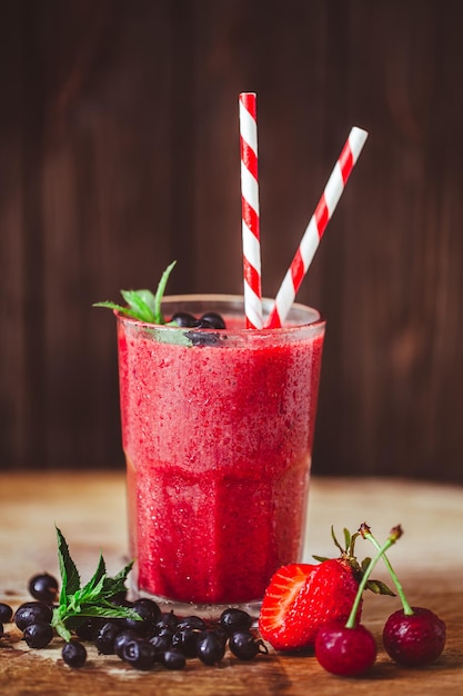 Vorderansicht des Glases mit frischem Purpur-Smoothie mit Beeren auf Holzhintergrund Gutes Essen