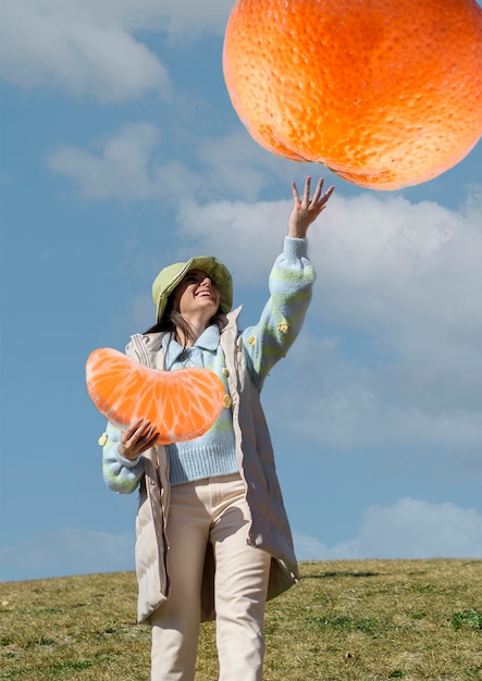 Foto vorderansichtfrau mit riesiger orange