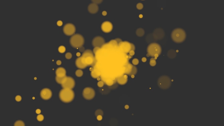 Foto vuela oro y amarillo bokeh abstracto y partículas en fondo brillante