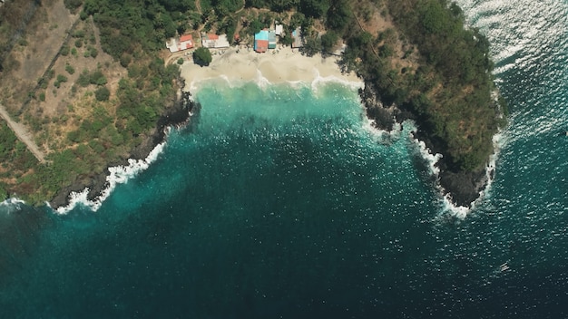 Vuelo aéreo de drone olas de la playa del océano en el paisaje de agua cristalina de arena blanca en la isla tropical de bali