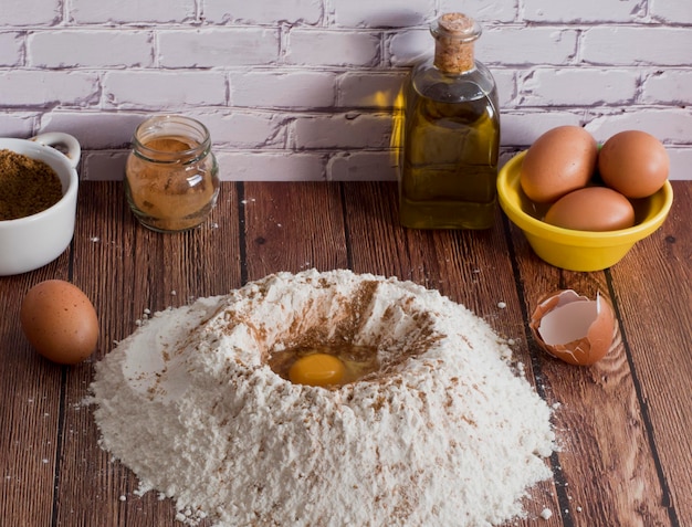 Vulcão de farinha com ovo na mesa de madeira