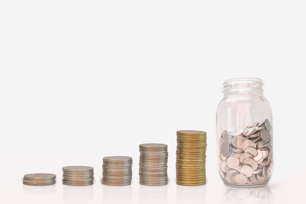 Wachstum des Münzenstapels und -geldes in der Glasflasche, auf weißem Hintergrund. Konzept Investition Geld zu sparen.
