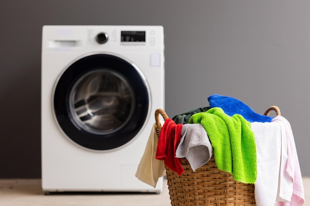 Wäschestapel im Korb und in der Waschmaschine stehen dicht beieinander.