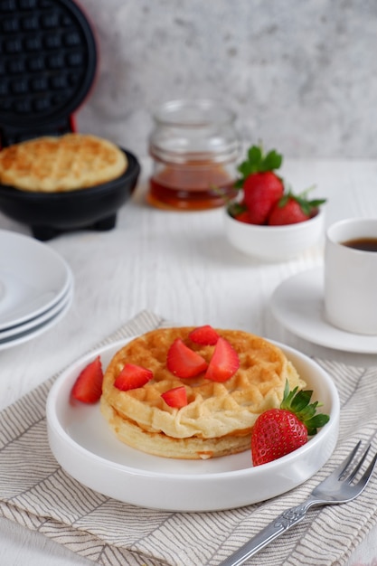 Waffeln mit Erdbeeren auf weißem Hintergrund