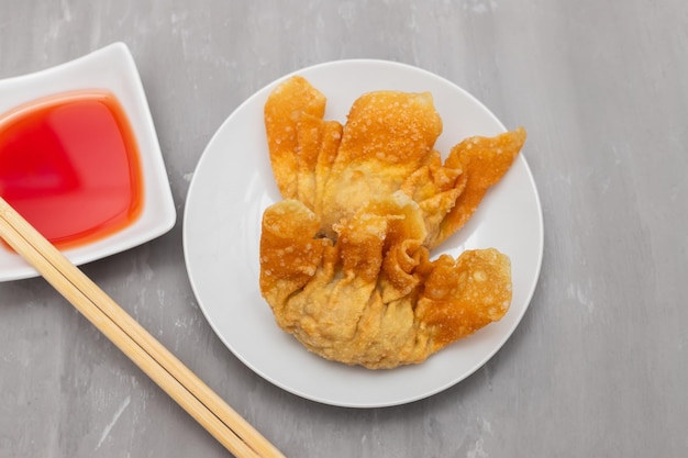 Wan tan frito en un plato pequeño blanco