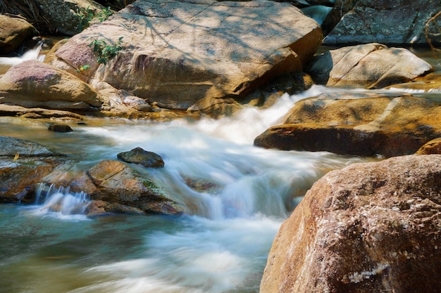 Wasser, das entlang Felsen im Naturwasserfall fließt