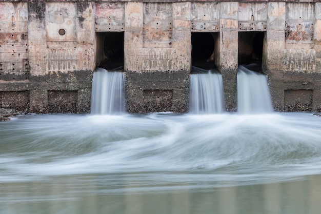 Wasser fließt vom Abfluss zum Fluss