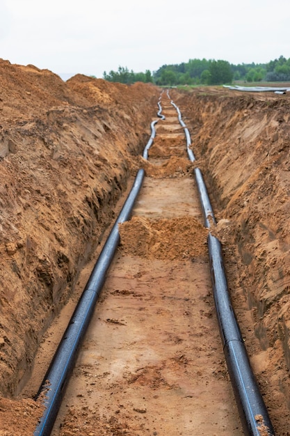Wasserleitungen für die Trinkwasserversorgung liegen auf der Baustelle Vorbereitung für Erdarbeiten zur Verlegung einer unterirdischen Rohrleitung Moderne Wasserversorgungssysteme für eine Wohnstadt