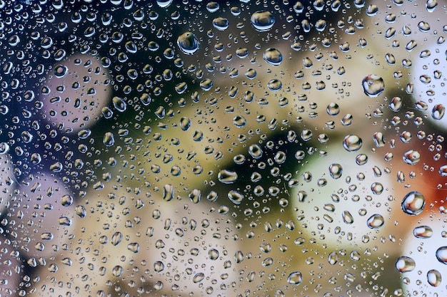 Wassertropfen, Regentropfen auf Glas mit einem schönen Hintergrund