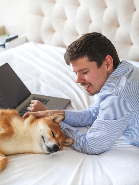 Foto webentwickler, der mit seinem hund im home office arbeitet