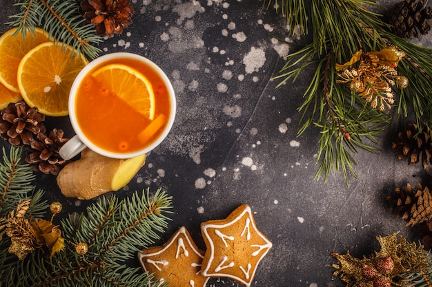 Weihnachten Hintergrund Sanddorntee mit Ingwer und Zitrusfrucht auf einem dunklen Hintergrund.