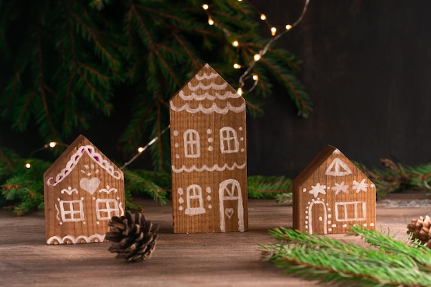 Weihnachten Holz-Hintergrund mit festlicher Dekoration handgefertigte hölzerne Lebkuchenhaus Sterne Kiefern Weihnachtshintergrund mit Exemplar