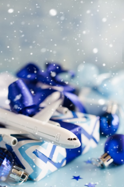 Weihnachten oder Neujahr Reisekonzept. Spielzeugflugzeug mit Pässen und Geschenkbox