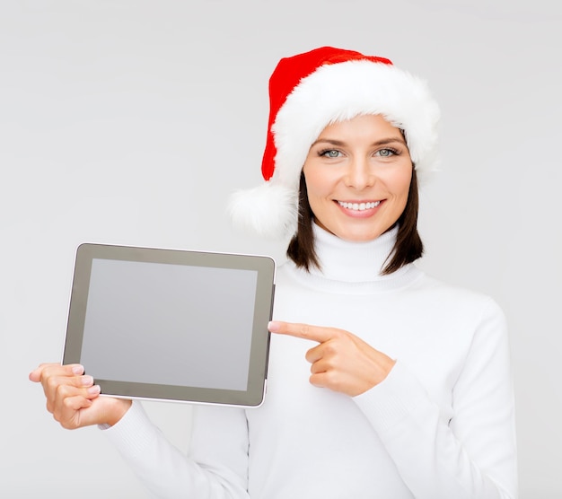 Weihnachten, Weihnachten, Elektronik, Gadget-Konzept - lächelnde Frau in Nikolausmütze mit leerem Bildschirm-Tablet-PC