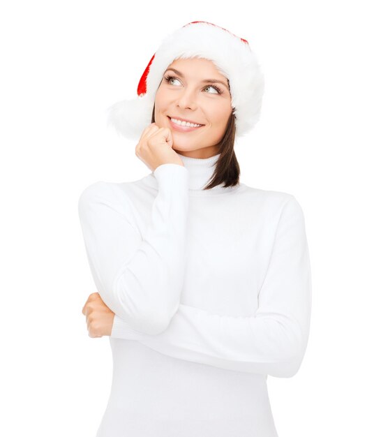 Weihnachten, Weihnachten, Winter, Glückskonzept - denkende und lächelnde Frau in Nikolausmütze