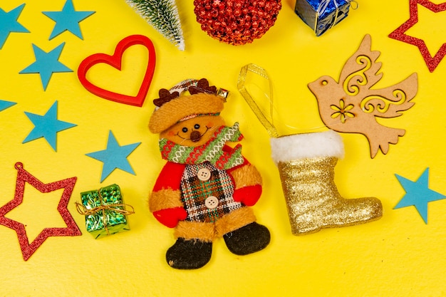 Weihnachtselemente mit Stern, Ball, Geschenkbox, in gelbem Hintergrund