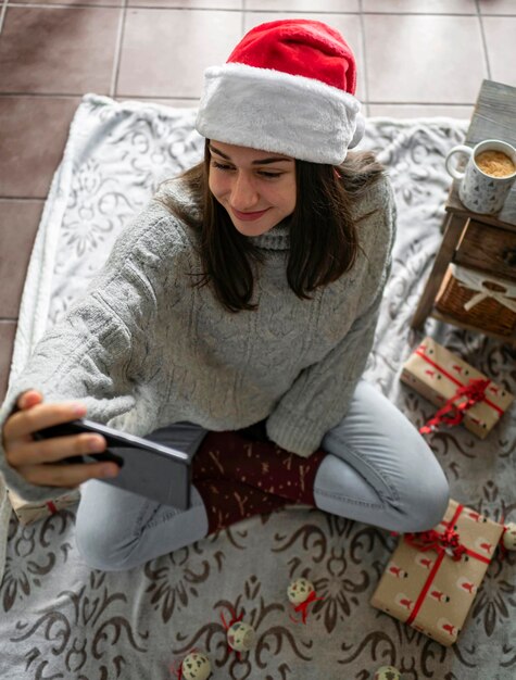 Weihnachtsferien online Glückliche Frau, die einen Videoanruf mit ihrer Familie oder Freunden hat