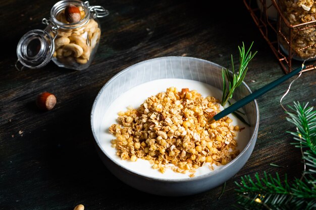 Weihnachtsfrühstück besteht aus Müsli mit Joghurt Weihnachtsmüsli mit Nüssen Winterurlaub Konzept Gesunde Ernährung Haferflocken-Snack