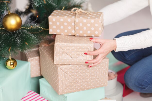 Weihnachtsgeschenke unter einen Baum stellen