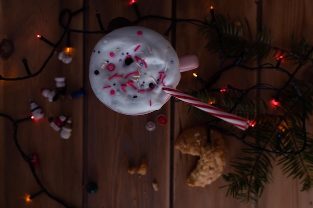 Weihnachtsgetränk mit hausgemachten Keksen auf einem Holztisch