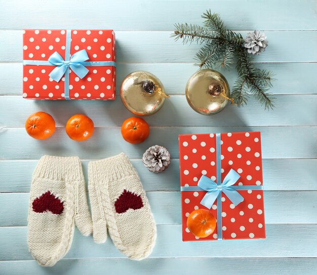 Weihnachtskomposition mit Geschenkboxen, Keksen und Dekorationen auf einem blauen Tisch