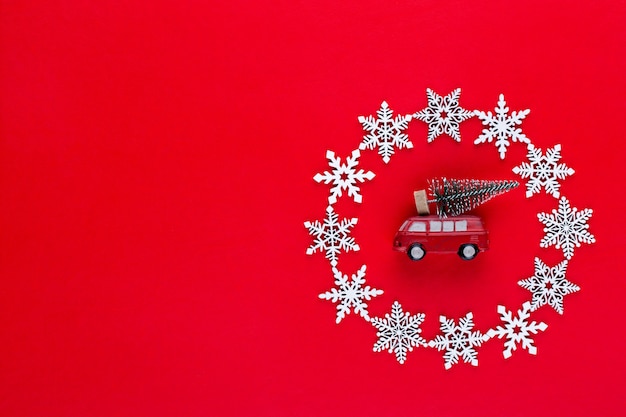 Weihnachtskomposition. Weiße Schneeflockenkranzdekorationen auf rotem Hintergrund. Weihnachts-, Winter-, Neujahrskonzept. Flache Lage, Draufsicht, Kopie.