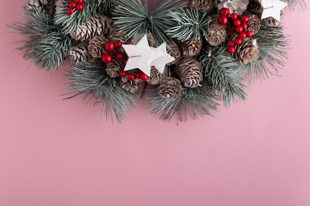 Weihnachtskranz auf rosa Hintergrund. Neujahrsmuster. Speicherplatz kopieren.