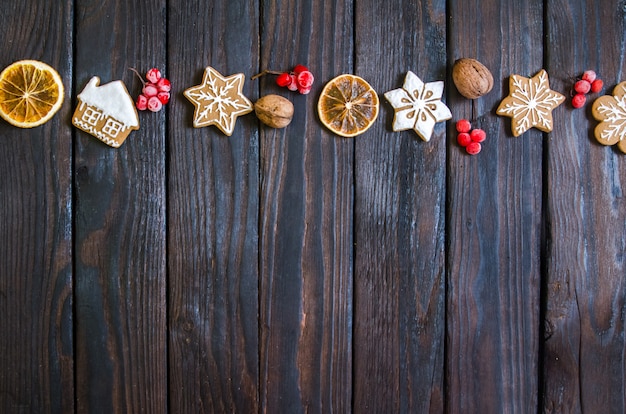 Weihnachtslebkuchen der verschiedenen Arten auf einem Schwarzweiss-hölzernen Hintergrund