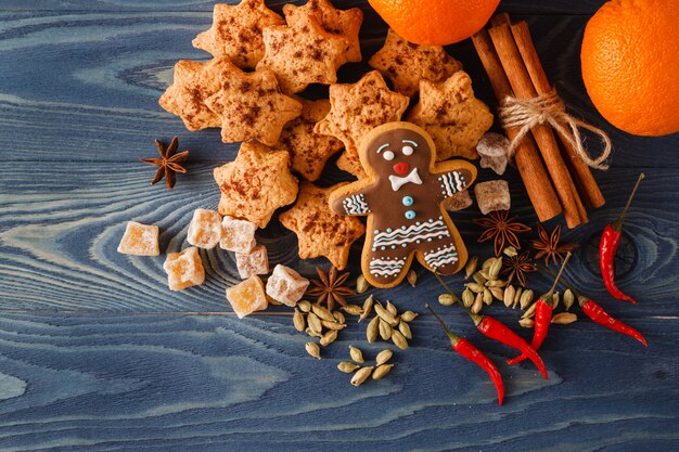 Weihnachtslebkuchenplätzchen und Gewürze auf hölzernem Hintergrund. Nahansicht