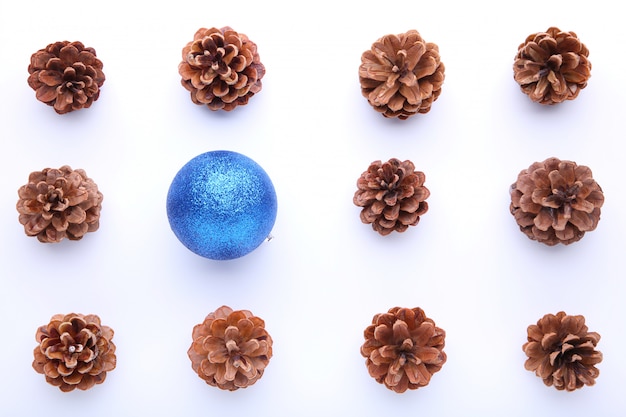 Weihnachtszusammensetzung mit Kiefernkegeln und blauem Weihnachtsball auf weißem Hintergrund