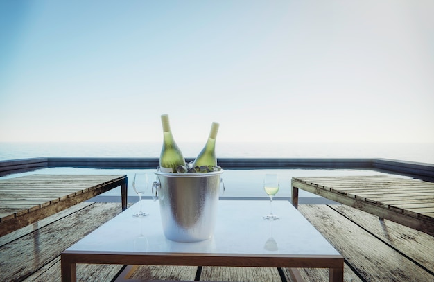 Weingläser und Weinflaschen werden mit Sitzen auf den Tisch gestellt. Pool seitlicher Meerblick