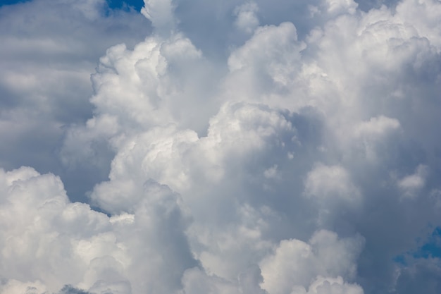 Weiße flaumige Wolken im Hintergrund des blauen Himmels