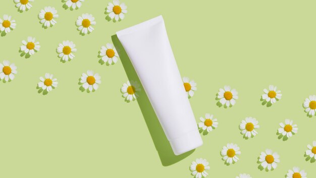 Weiße Kosmetiktube mit Kamille auf grünem Hintergrund Flacher Kopienraum Leer für Branding-Mockup