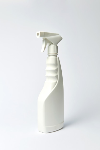 Weiße Plastikflasche für Flüssigkeit auf hellgrauem Hintergrund. Platz für Text.