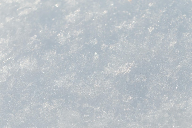 Foto weiße schnee-textur mit schneeflocken in nahaufnahme