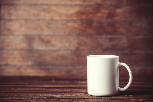 Weiße Tasse auf Holztisch