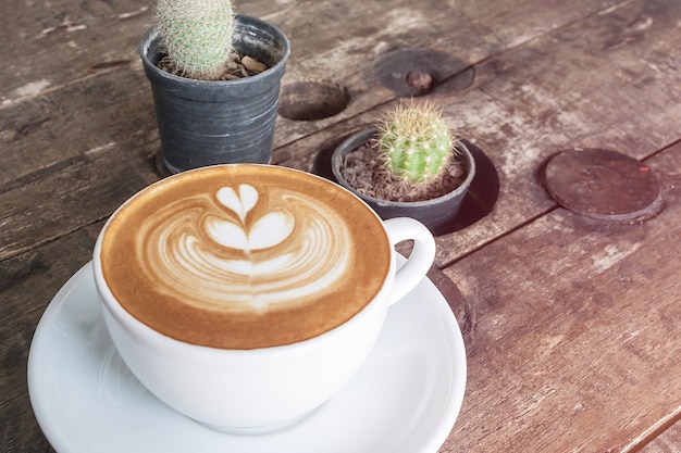 weiße Tasse Kaffee Latte auf dem Schreibtisch aus Holz