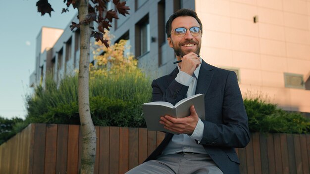 Weißer Mann nachdenklich kluger Geschäftsmann männlicher Lehrer Schriftsteller Typ im Freien denkt kreative Ideen