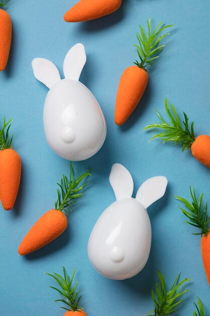 Weißer Osterhase mit orangefarbenen Karotten Ostern-Komposition