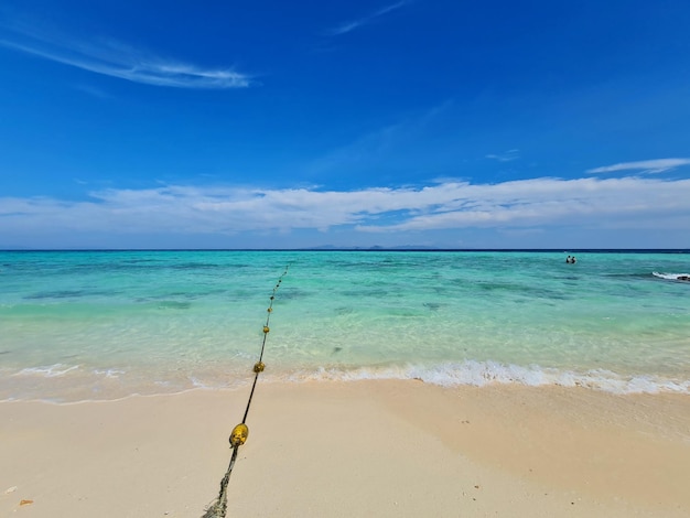 Weißer Strand mit blauem Meer und blauem Himmel in Thailand