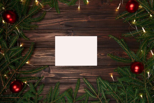 Weißes Blatt Papier in einem Weihnachtskranzrahmen. Foto mit Platz für Text.