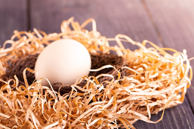 Foto weißes ei auf nest auf altem holz