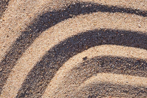 Wellenmuster aus natürlichem Strandsandhintergrund für Sommerdesigns