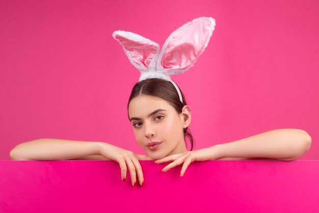 Werbung zu Ostern. Mädchen mit Hasenohren. Kaninchenfrau mit Farbtafel.