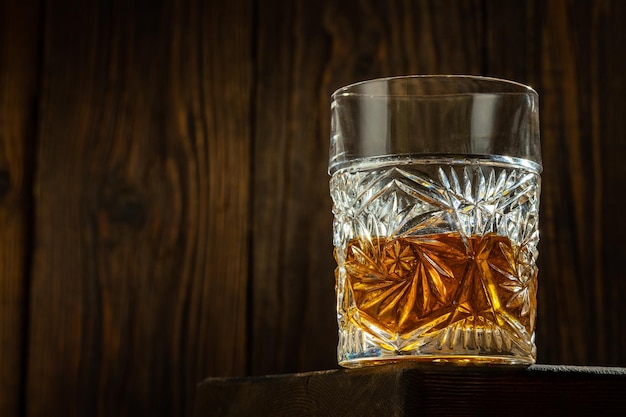 Whisky con hielo en una mesa de madera